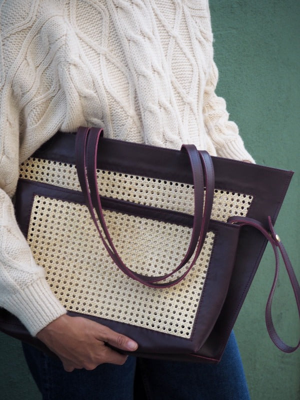 Burgundy  leather tote bag and clutch bag in handwoven rattan weave 